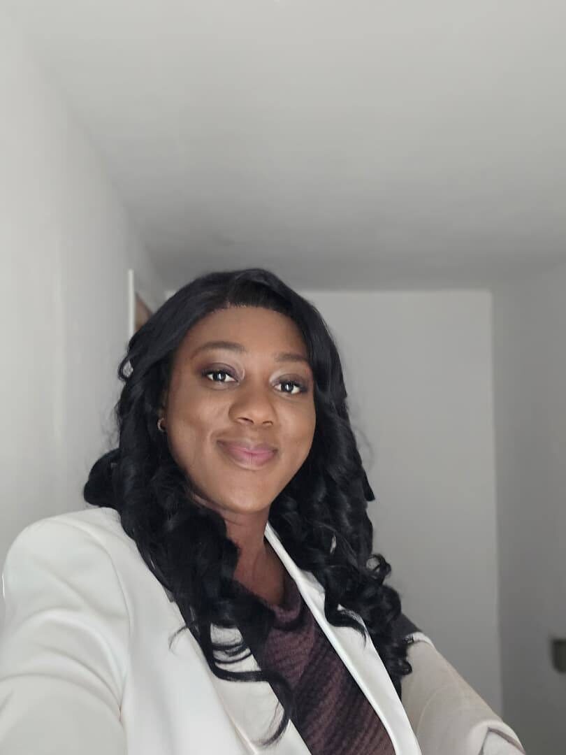 Close portrait of Omowunmi in a white blazer